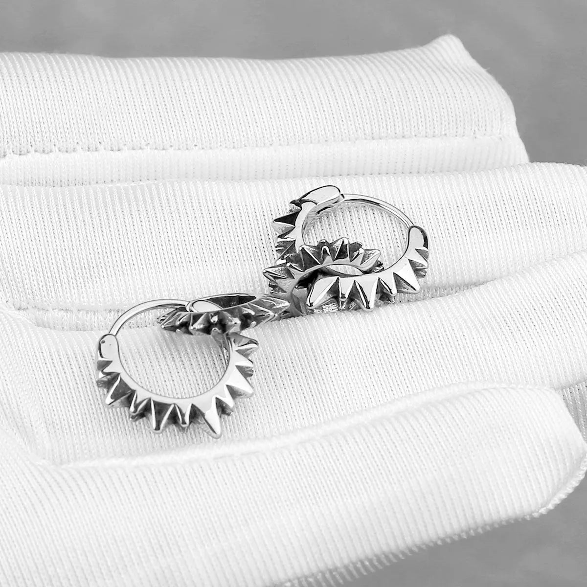Stainless steel round ring earrings with polished steel finish and retro design influences