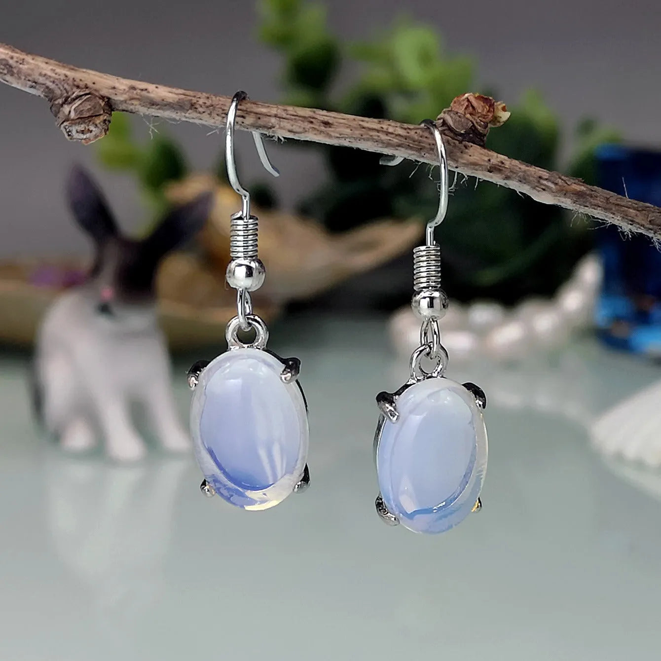 Retro moonstone opal earrings with cross design and drop-shaped elliptical pendants