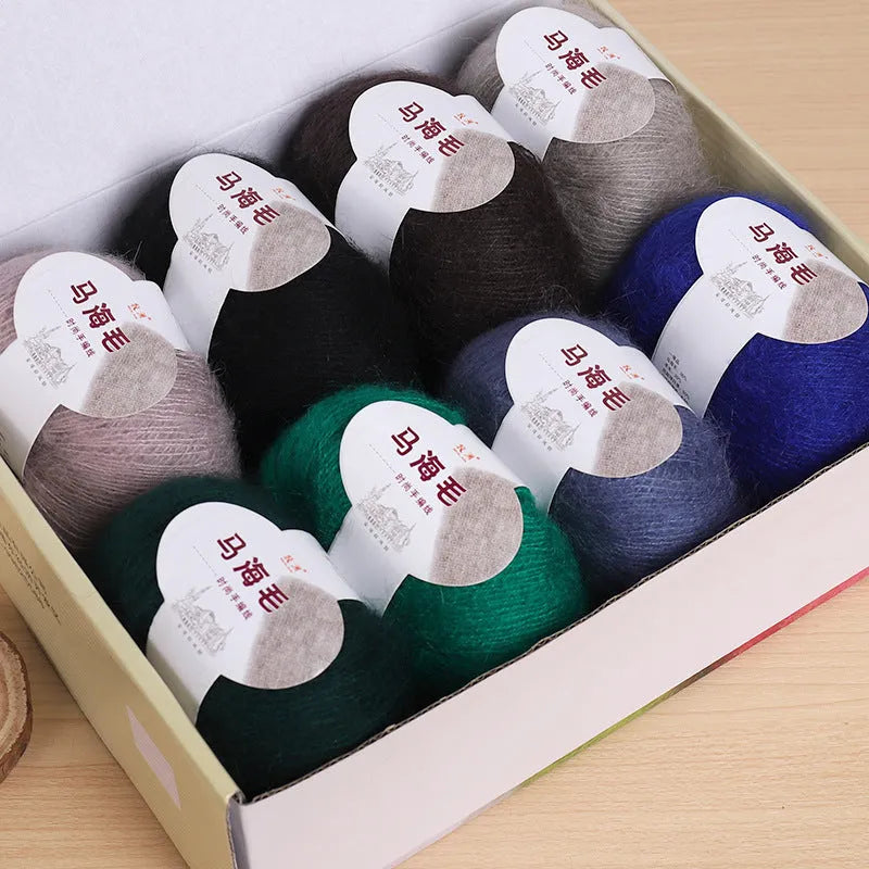 Single ball of mohair yarn in various colours for hand-woven DIY scarf knitting projects