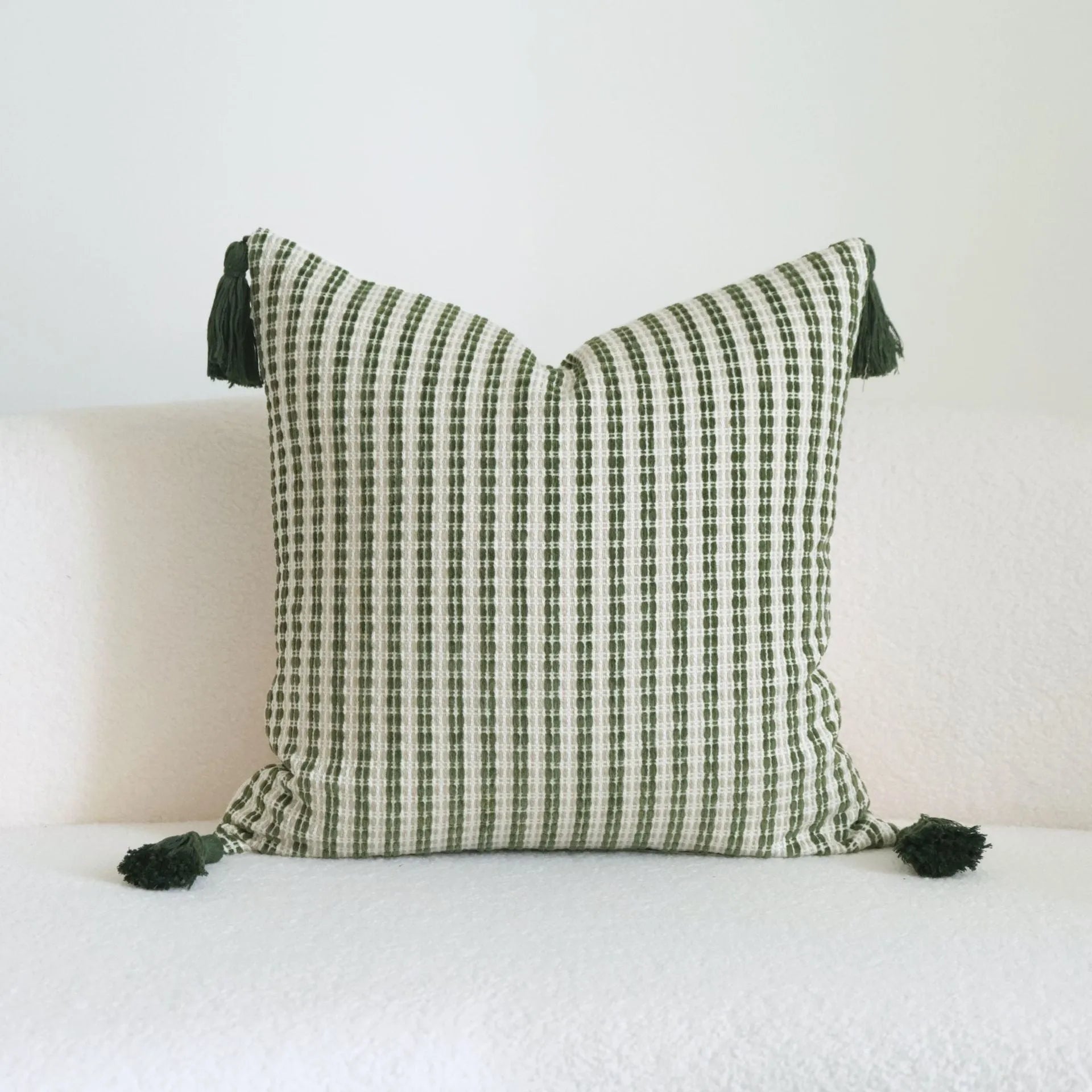 Green cotton and linen hotel sample pillow with botanical pattern and tassel trim