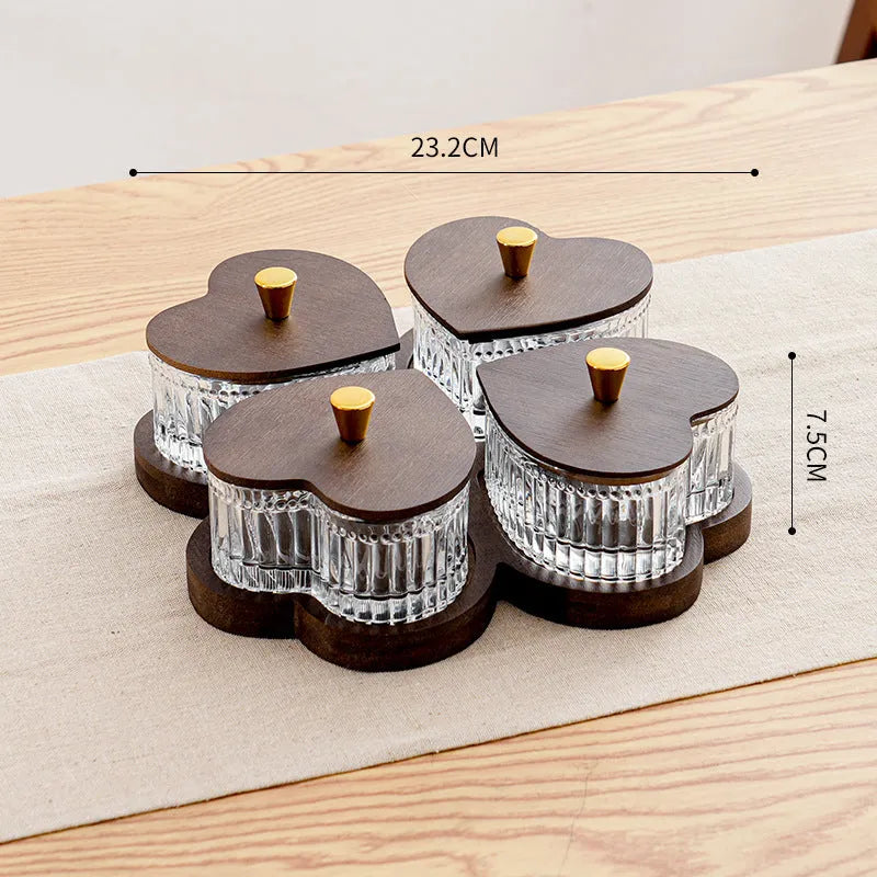 Transparent heart-shaped glass snack plate with multiple compartments and lids for organised food serving