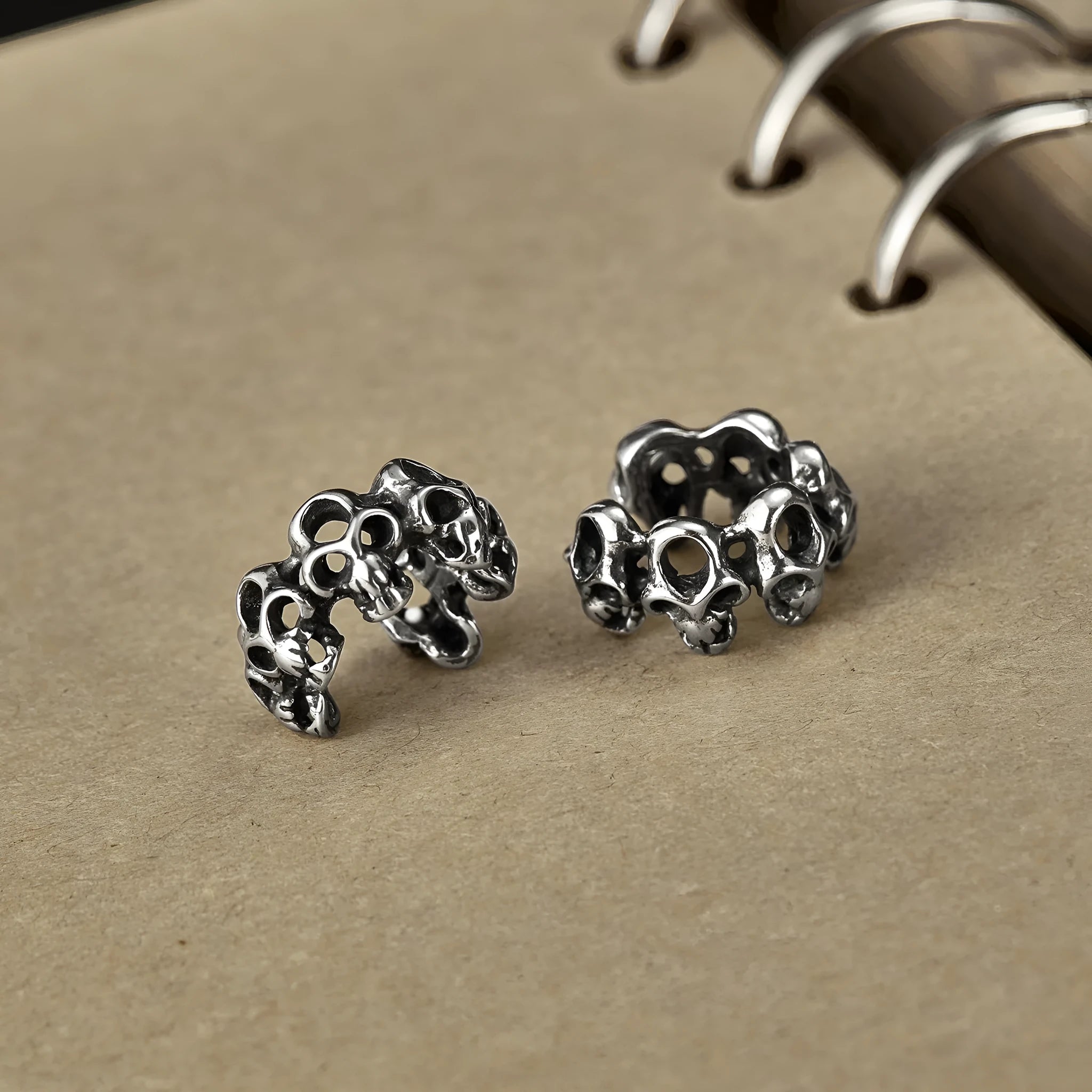 Stainless steel skull earrings with clip-on fastening and hollow geometric design