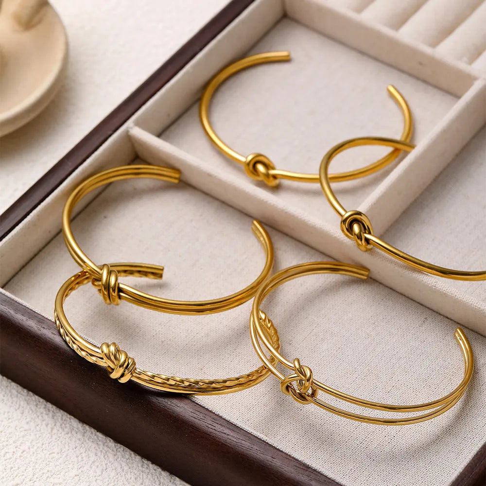 Women's adjustable knotted C-shaped open double-layer bracelet in gold or silver plated stainless steel.
