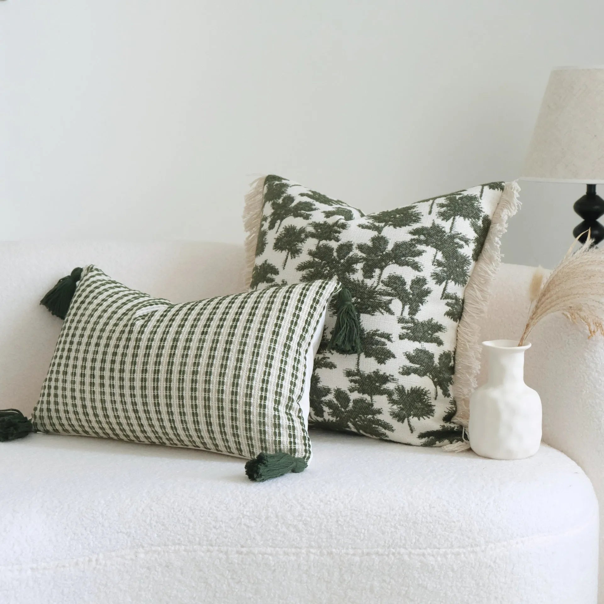Green cotton and linen hotel sample pillow with botanical pattern and tassel trim