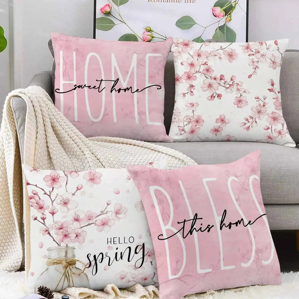 Short velvet square cushion cover with cherry blossom letter print, shown in one of four colour options.