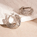 Women's geometric hollow stud earrings with twisted round design in gold and silver colour options