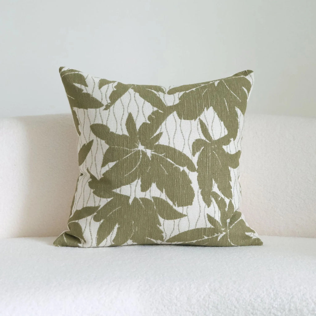 Green cotton and linen hotel sample pillow with botanical pattern and tassel trim