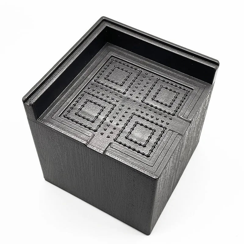 Four black plastic furniture riser feet for bed and sofa height adjustment