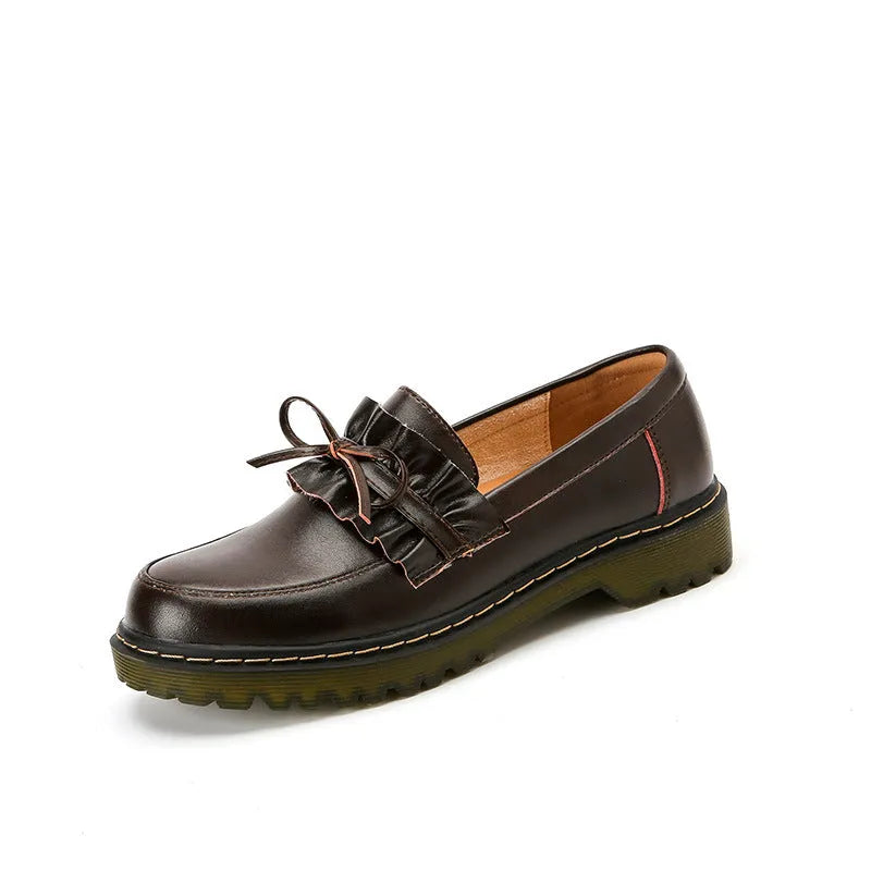 Black and brown women's round toe leather shoes with a chunky flat heel and low upper.