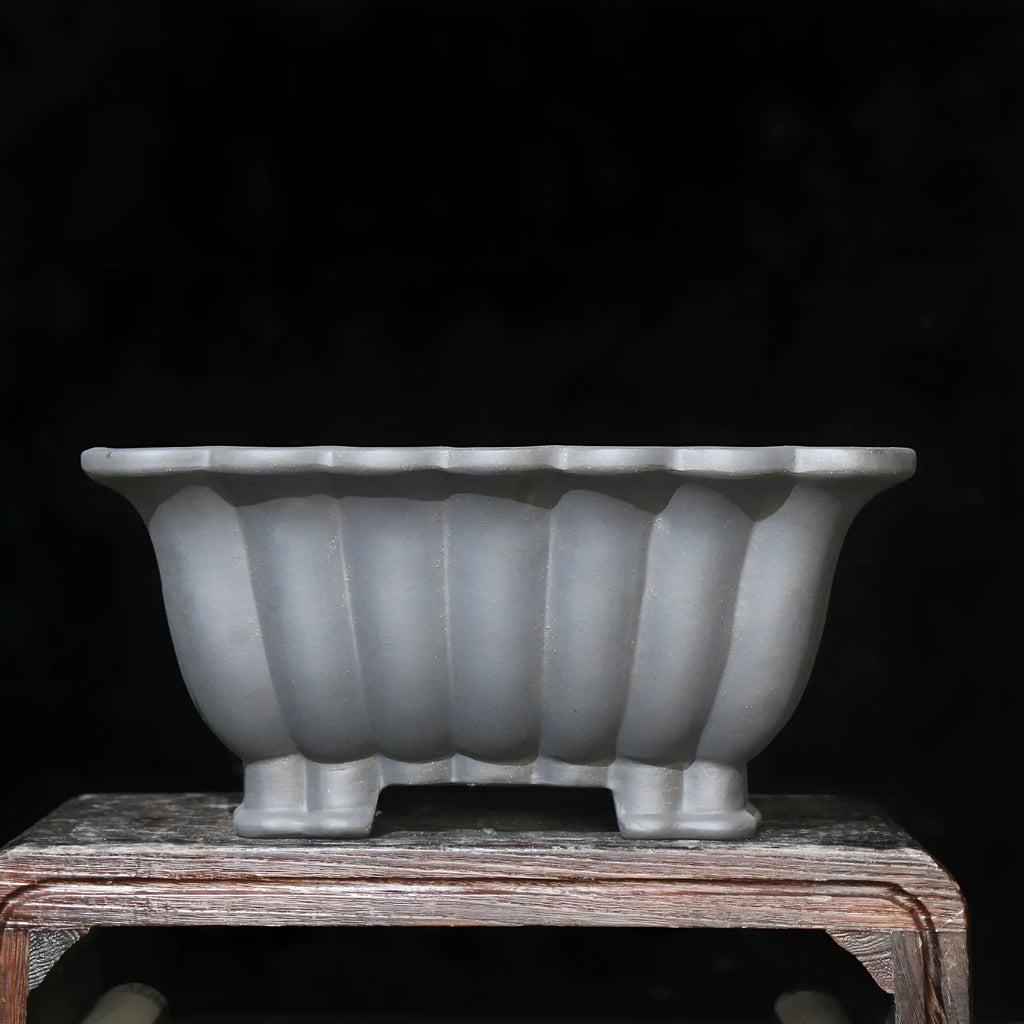 Square purple sand ceramic bonsai pot with classical styling on desktop