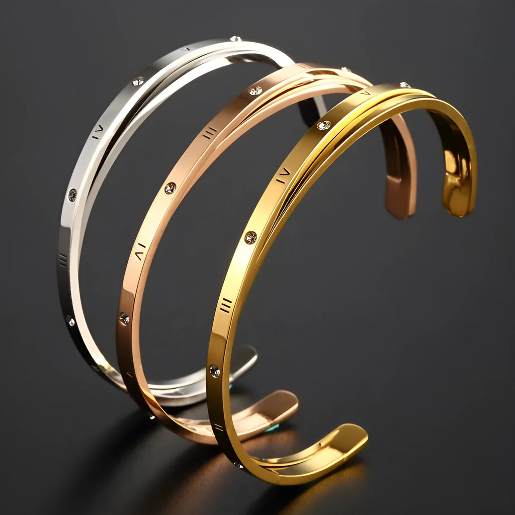 Open-ended stainless steel bracelet with inlaid zircon stones available in rose gold, steel, and gold electroplated finishes