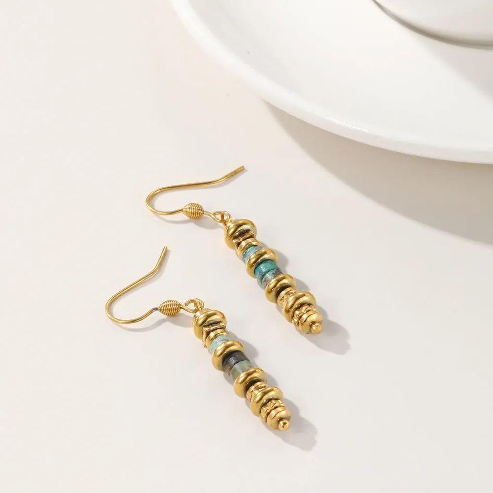 Pair of silver geometric-shaped titanium steel dangle earrings with an 18K gold finish.