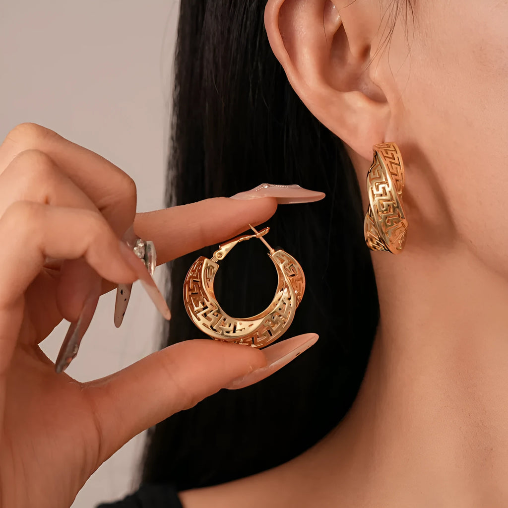 Women's geometric hollow stud earrings with twisted round design in gold and silver colour options