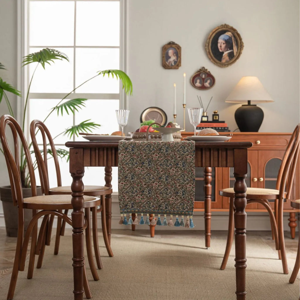 Dark blue striped Nordic jacquard bouquet table runner with tassel trim laid flat on a table.