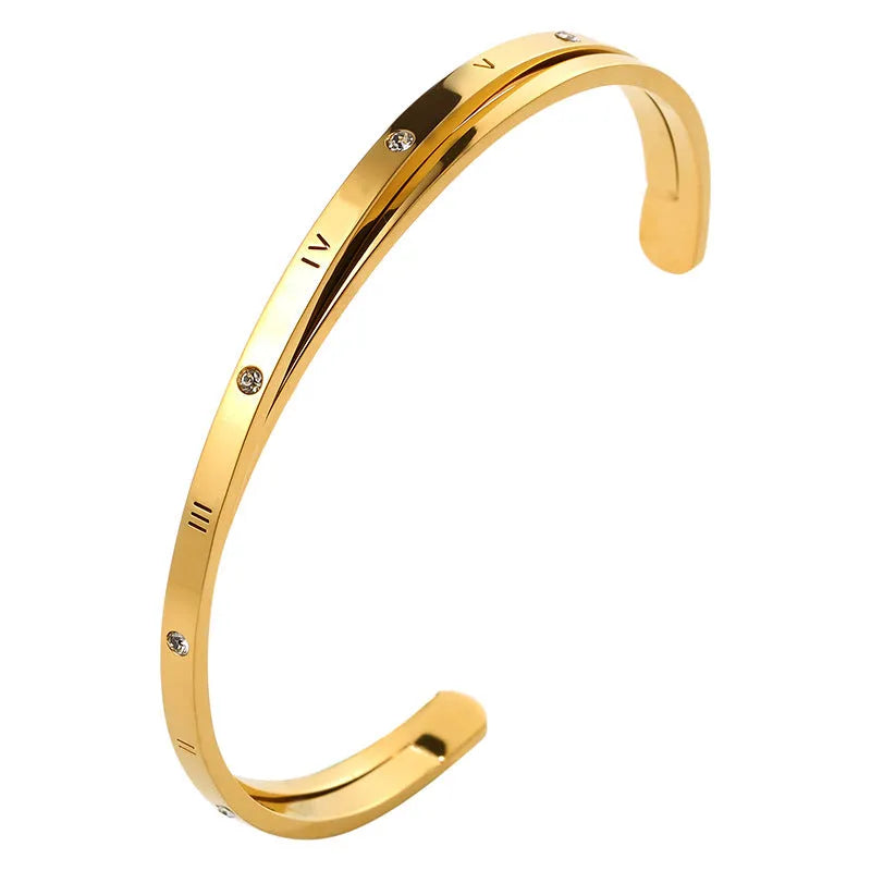 Open-ended stainless steel bracelet with inlaid zircon stones available in rose gold, steel, and gold electroplated finishes