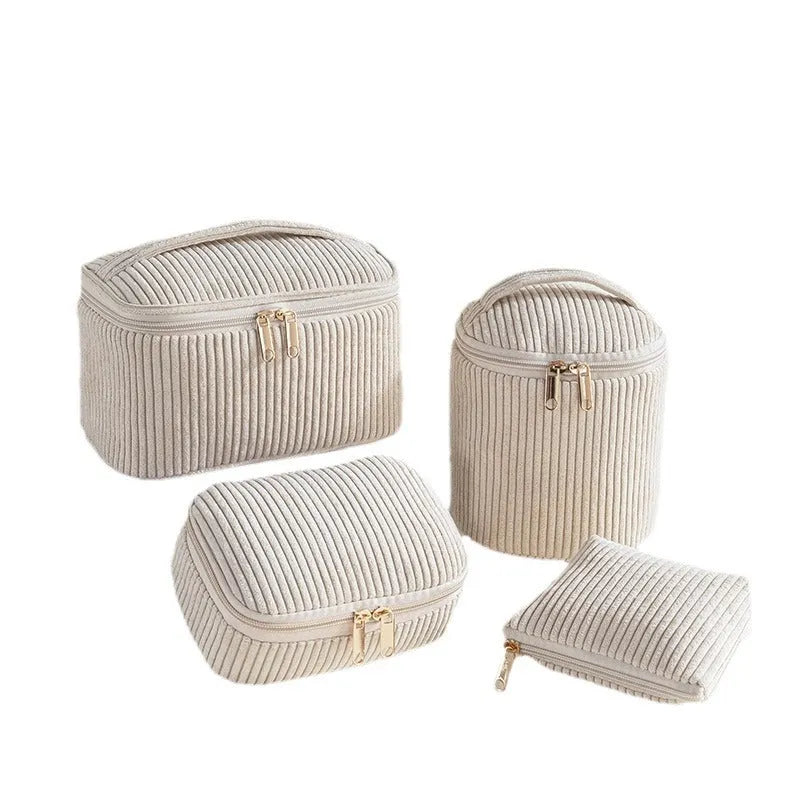 Four cube-shaped polyester makeup bags in coordinated set for cosmetics organisation