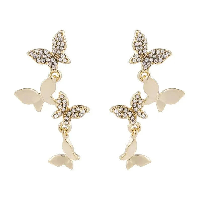 Gold-coloured copper earrings with butterfly design in ear drop style for women