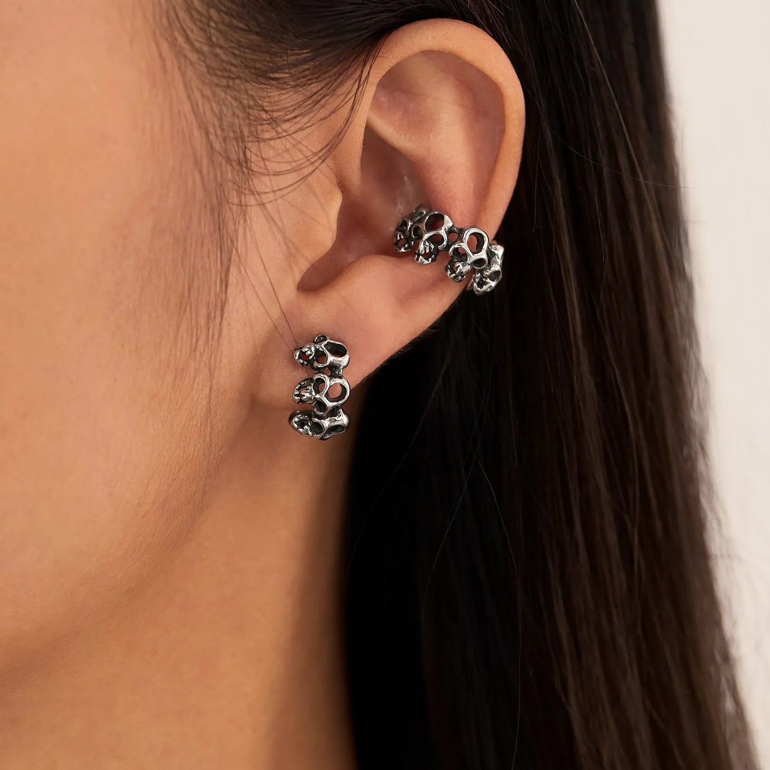 Stainless steel skull earrings with clip-on fastening and hollow geometric design