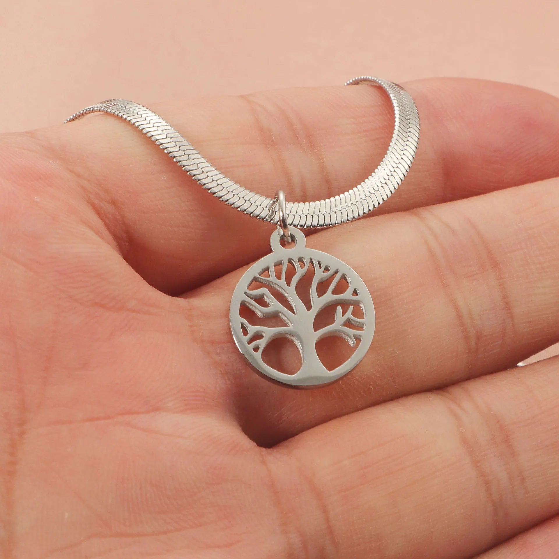 Stainless steel tree pendant necklace on a textured snake bone chain, shown in gold colour.