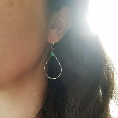 Circular geometric earrings with turquoise centre and antique silver finish