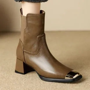 Brown women's cowhide Martin ankle boots with a high heel and side zipper on a white background.
