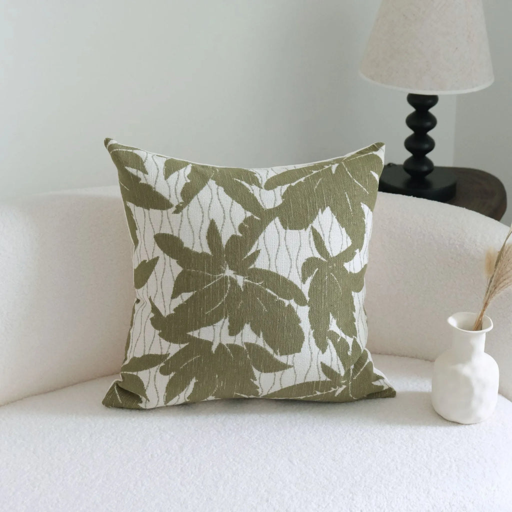 Green cotton and linen hotel sample pillow with botanical pattern and tassel trim