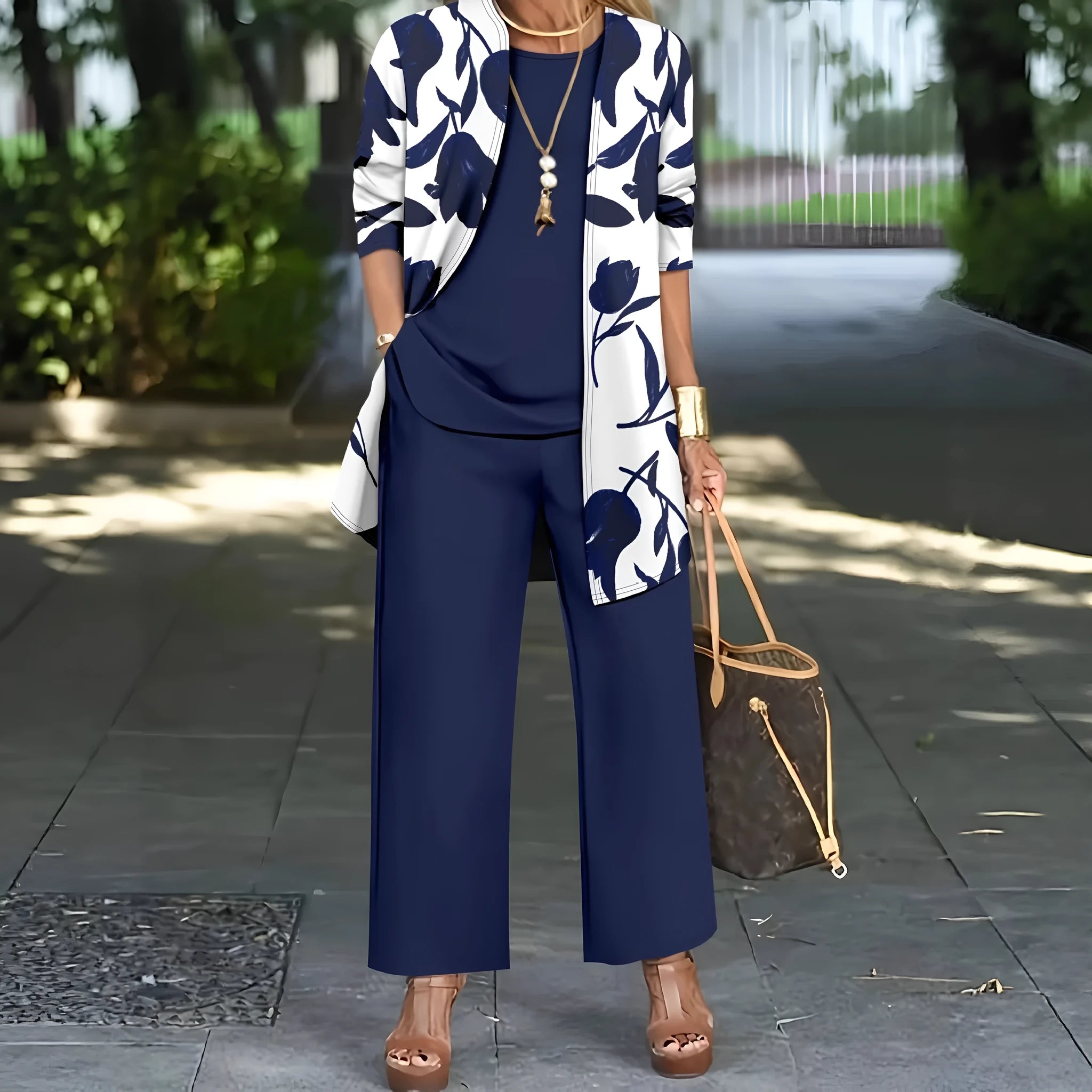 Women's blue three-piece casual suit featuring a long-sleeve coat, a vest, and full-length trousers.