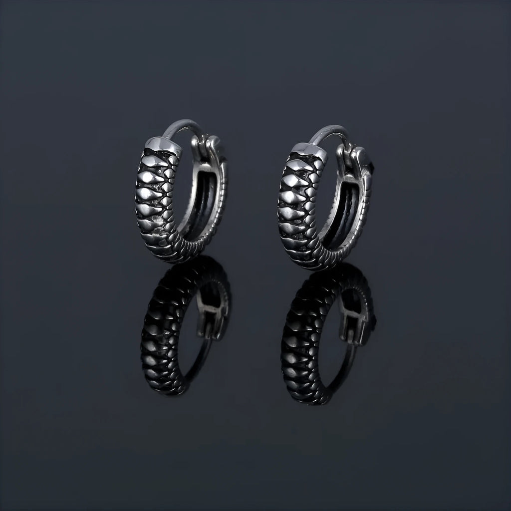 Silver geometric earrings with retro twist design and striped detailing on circular stainless steel form