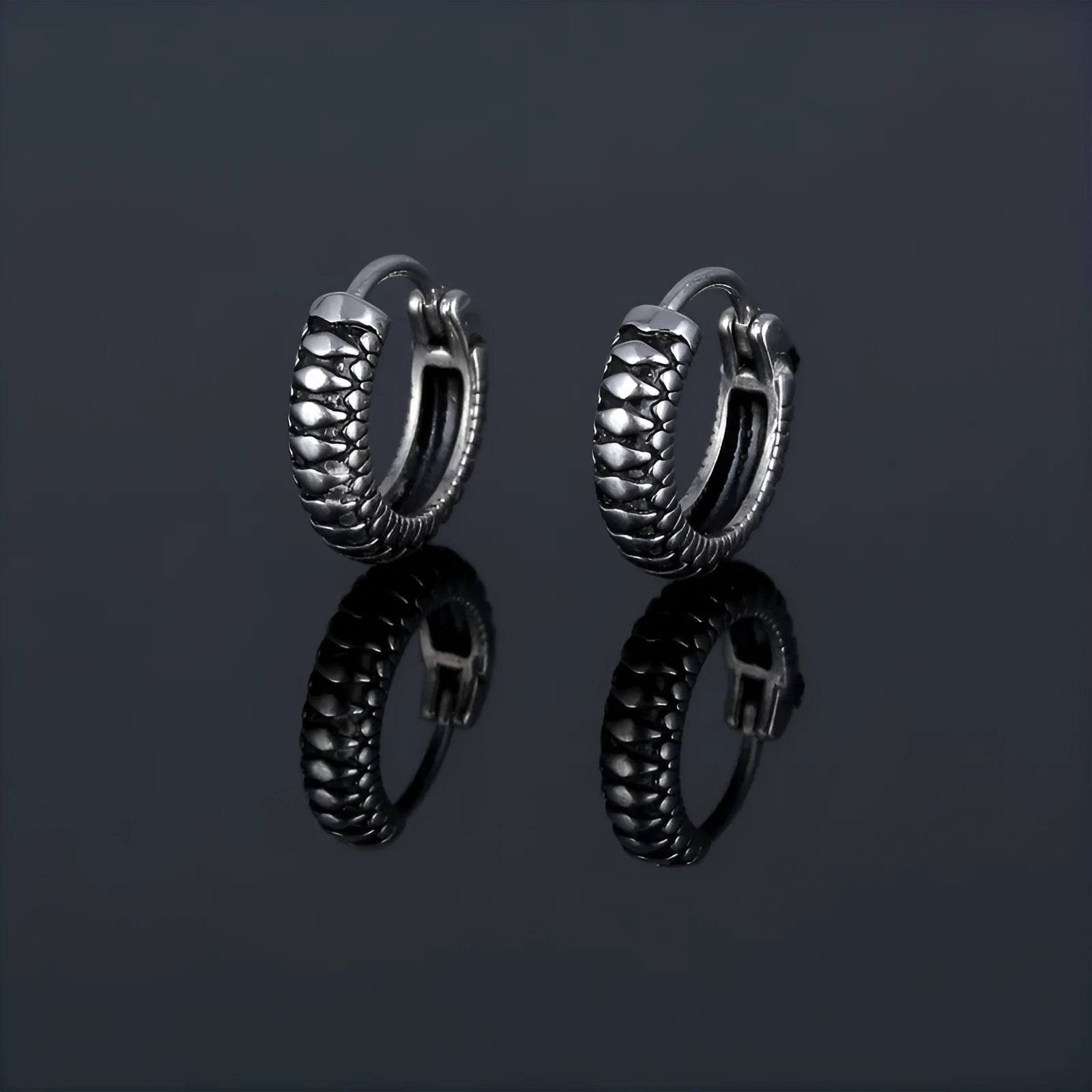 Silver geometric earrings with retro twist design and striped detailing on circular stainless steel form