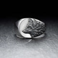 Men's silver geometric wolf head ring on a grey background showing detailed alloy construction.