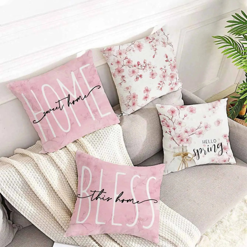 Short velvet square cushion cover with cherry blossom letter print, shown in one of four colour options.