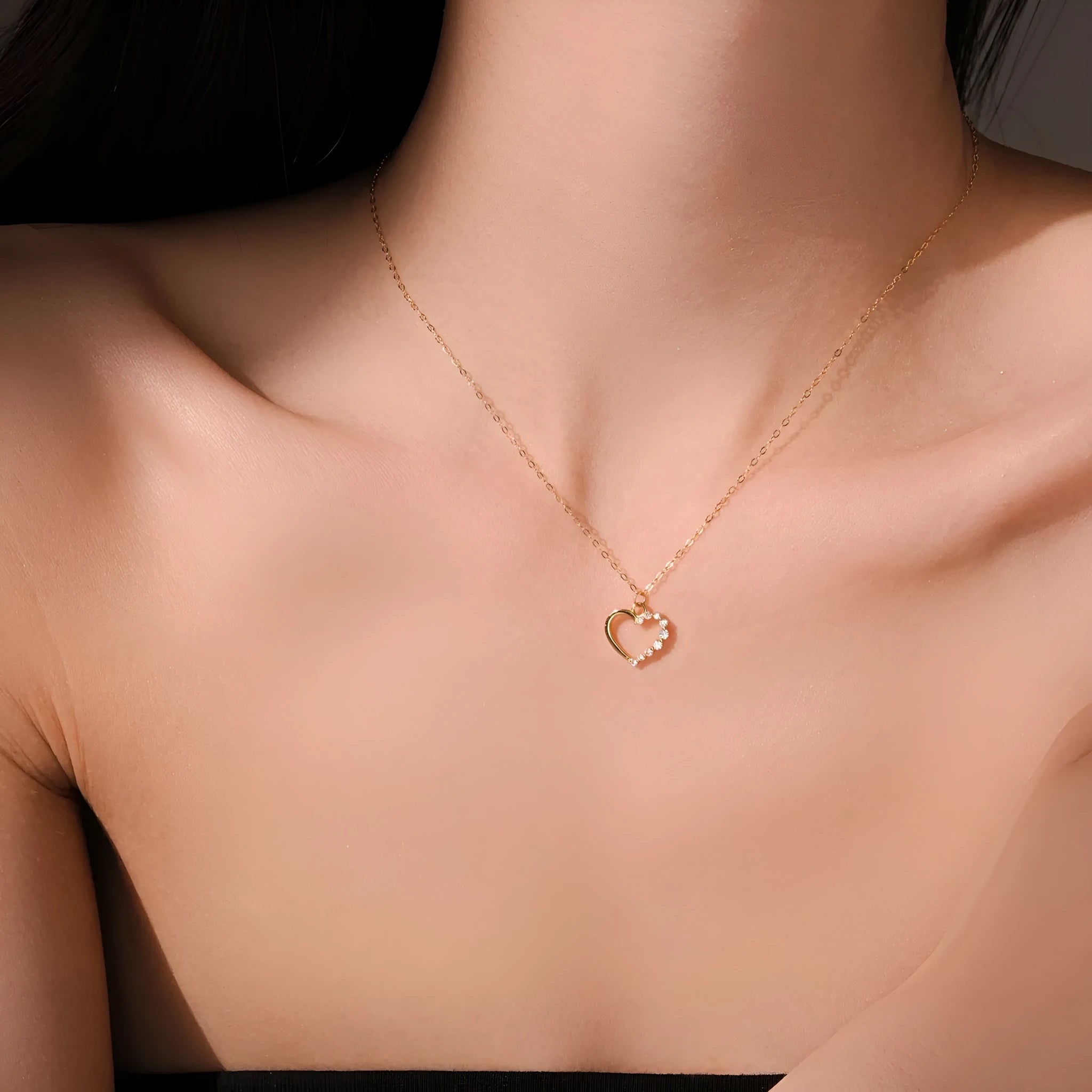 Close-up of a women's sterling silver hollow heart necklace with a circle detail, showing the white gold finish option.