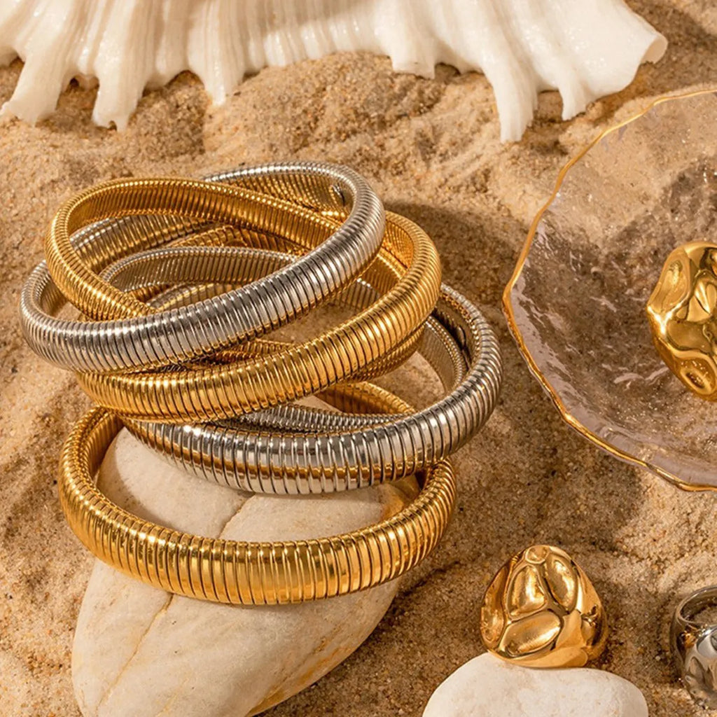 Women's elastic titanium steel bracelet with vertical stripe ring pattern in gold electroplated finish
