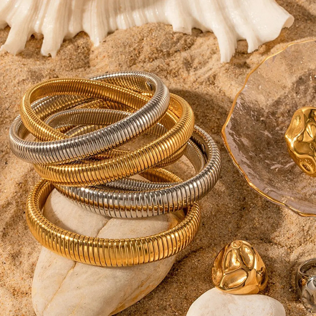 Women's elastic titanium steel bracelet with vertical stripe ring pattern in gold electroplated finish