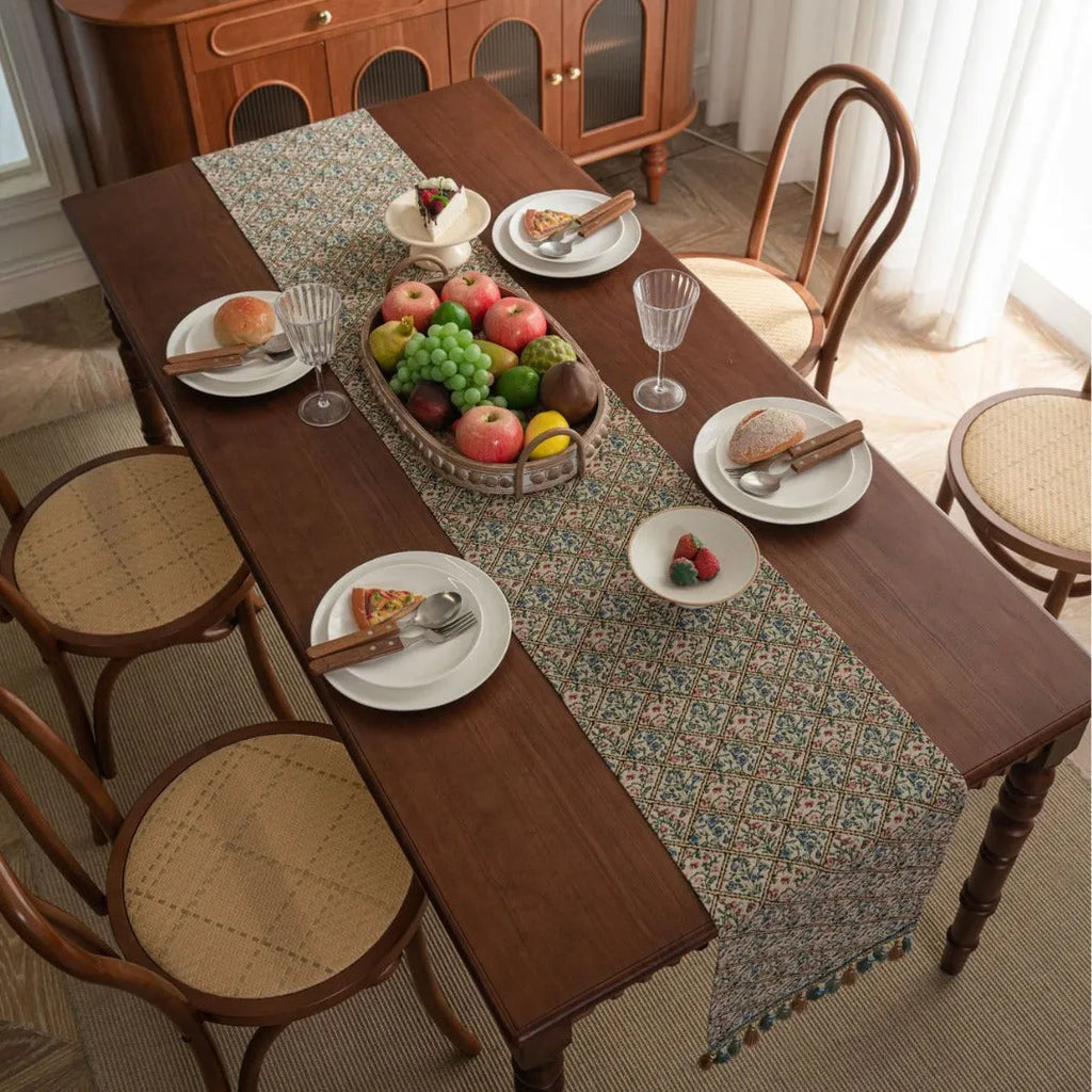 Dark blue striped Nordic jacquard bouquet table runner with tassel trim laid flat on a table.