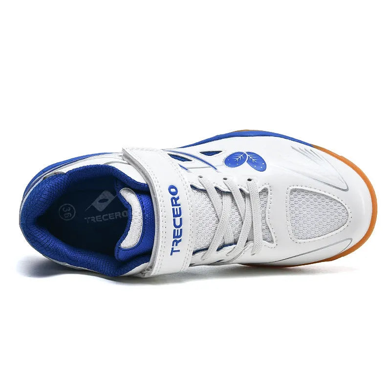 White and blue breathable PVC badminton shoes with a ribbed sole on a court surface.
