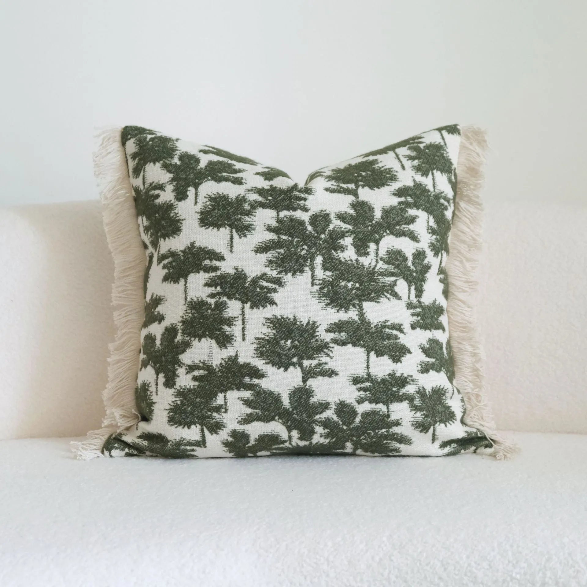 Green cotton and linen hotel sample pillow with botanical pattern and tassel trim