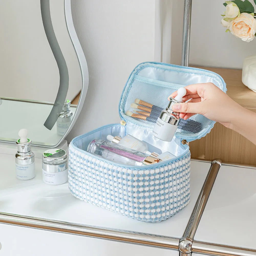 Four cube-shaped polyester makeup bags in coordinated set for cosmetics organisation