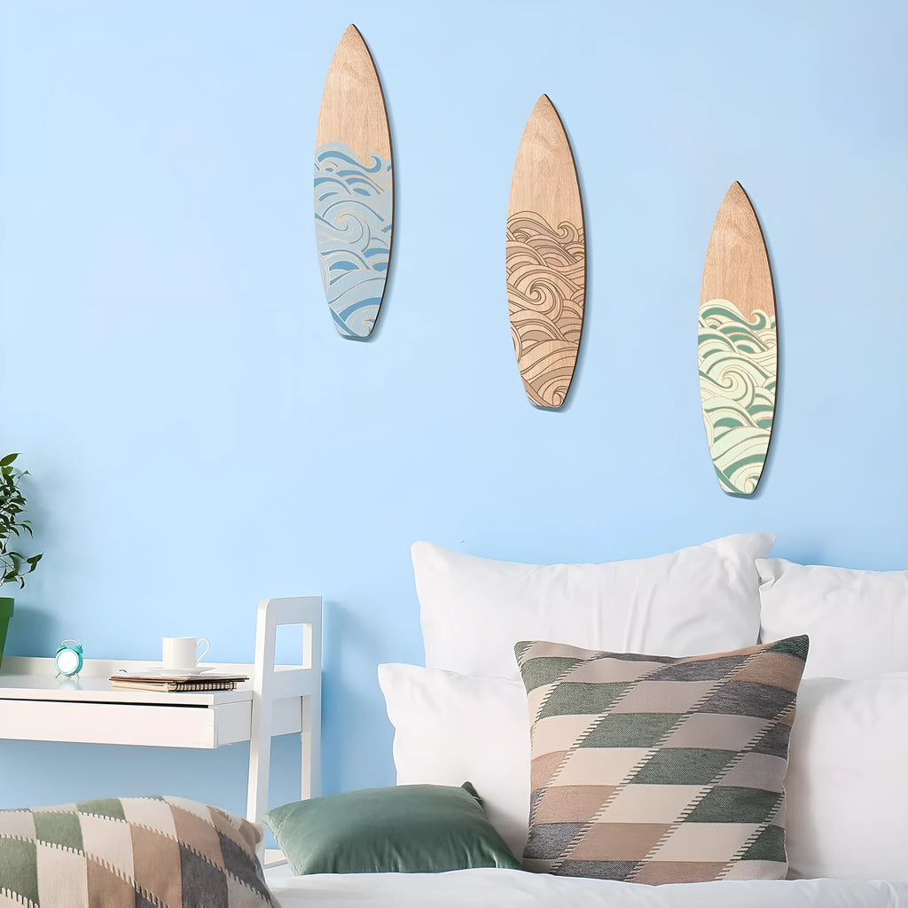 Three identical wooden surfboard-shaped wall decorations made from boxwood on a plain background.
