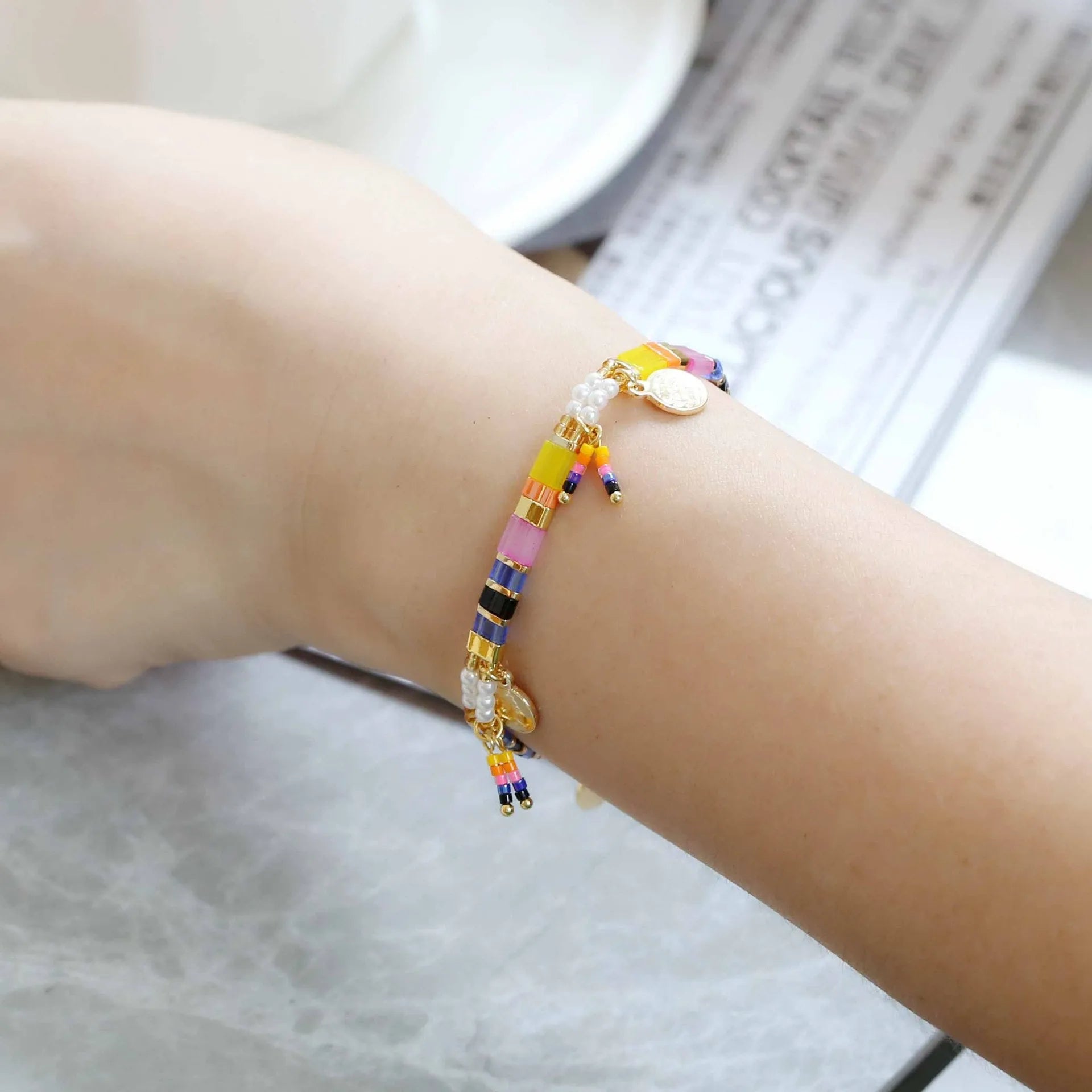Women's imitation pearl beaded bracelet with glass coloured beads in six pearl lifting colour options