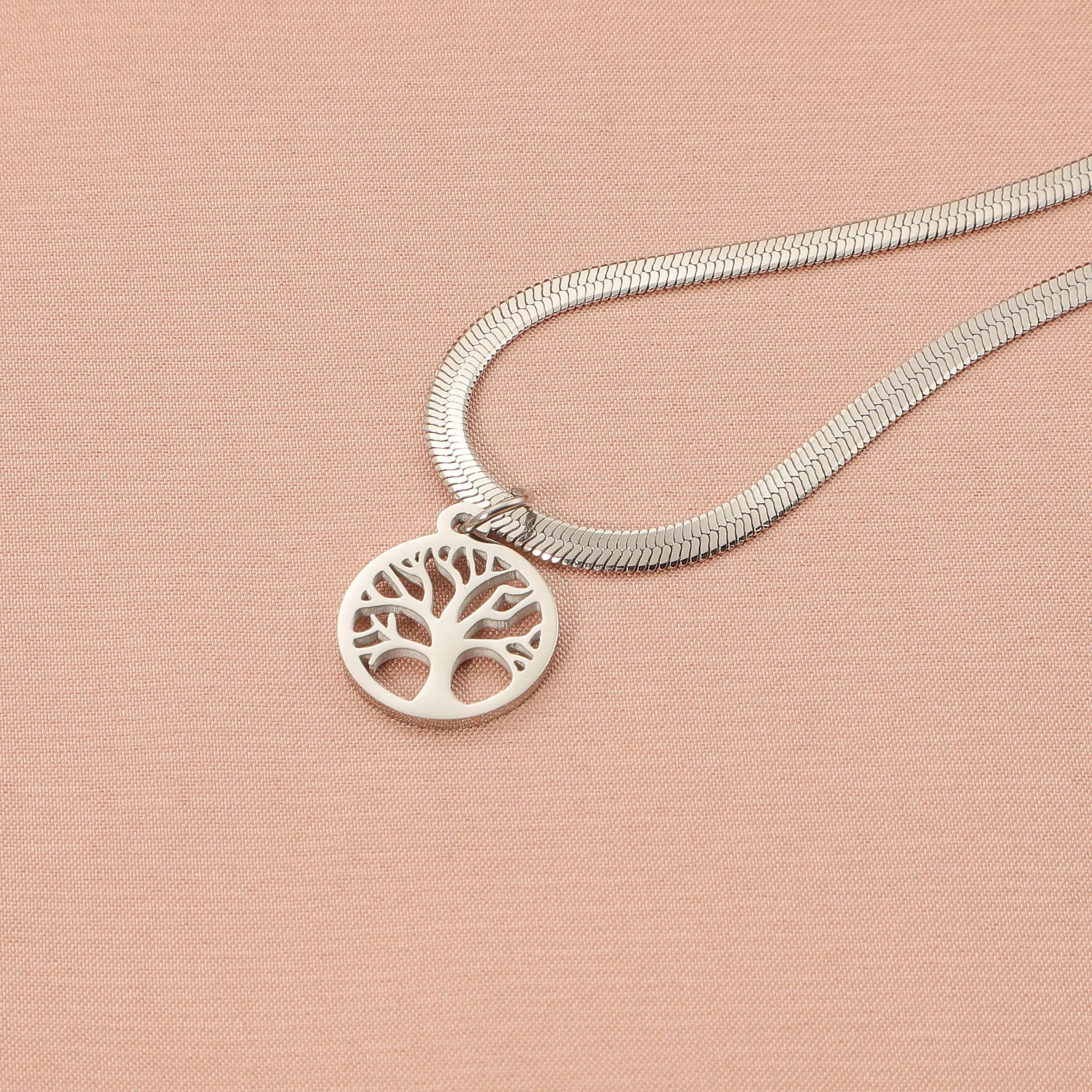 Stainless steel tree pendant necklace on a textured snake bone chain, shown in gold colour.