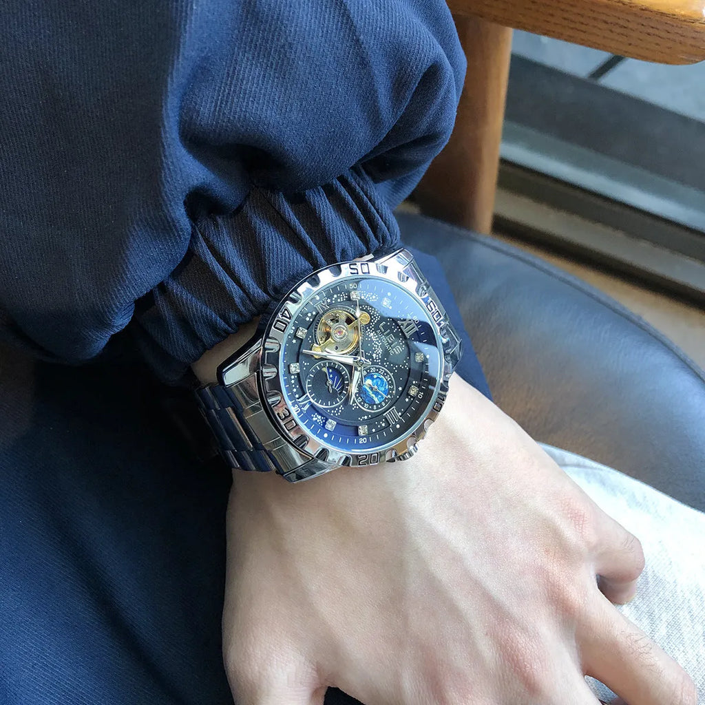 Men's silver automatic mechanical watch with black starry dial, luminous hands, and a leather strap.