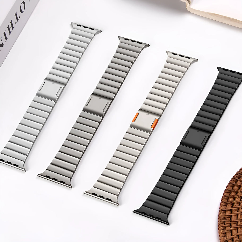 Stainless steel Apple Watch strap with magnetic buckle in multiple colour options on a wrist.