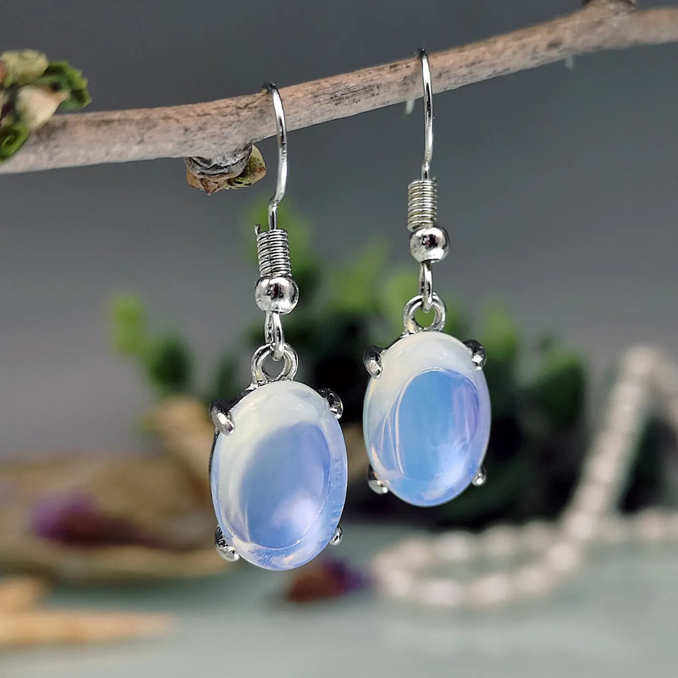 Retro moonstone opal earrings with cross design and drop-shaped elliptical pendants