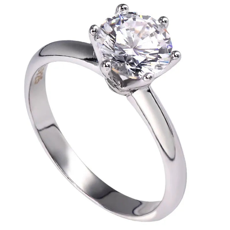 White gold-plated women's ring with six-claw setting holding geometric zircon stones