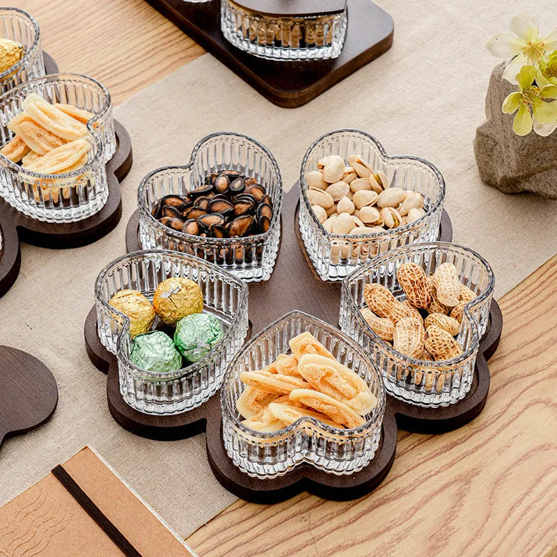 Transparent heart-shaped glass snack plate with multiple compartments and lids for organised food serving