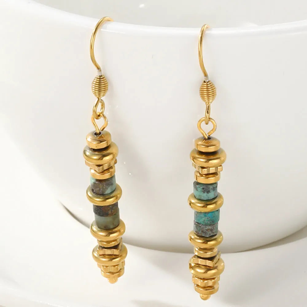Pair of silver geometric-shaped titanium steel dangle earrings with an 18K gold finish.