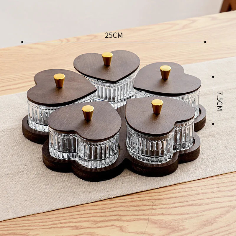 Transparent heart-shaped glass snack plate with multiple compartments and lids for organised food serving