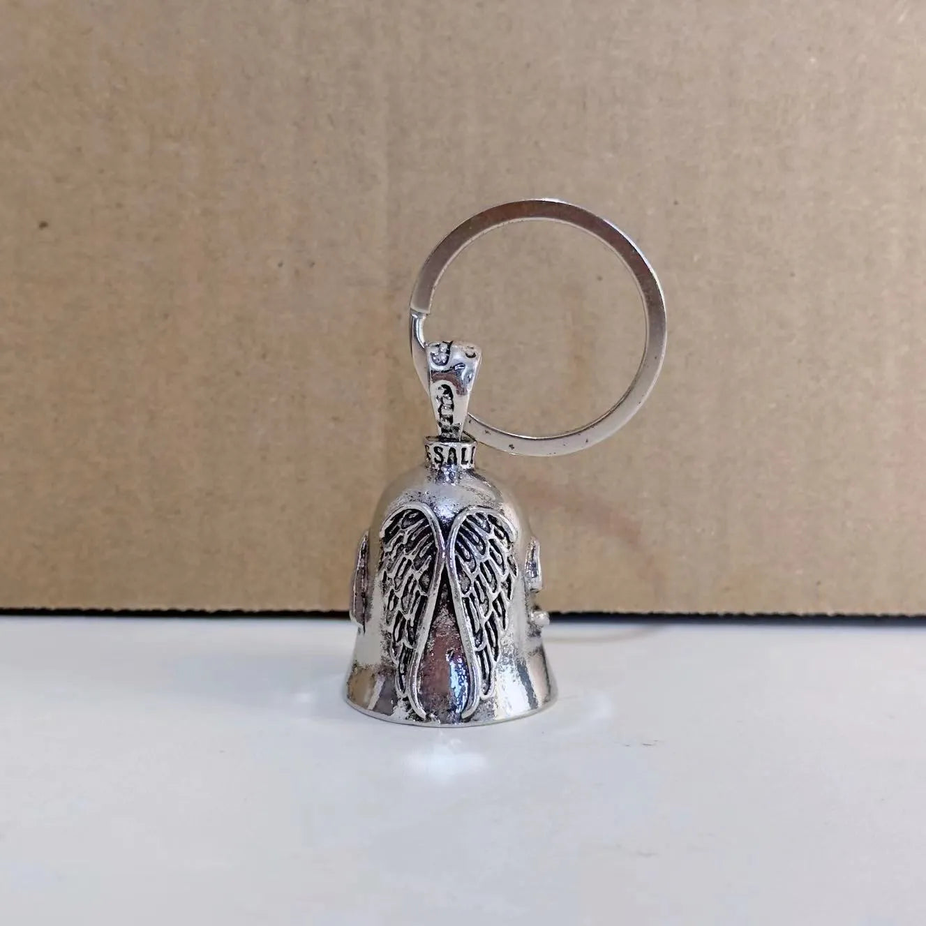 Vintage white electroplated alloy angel feather pendant on a keychain and a necklace chain.