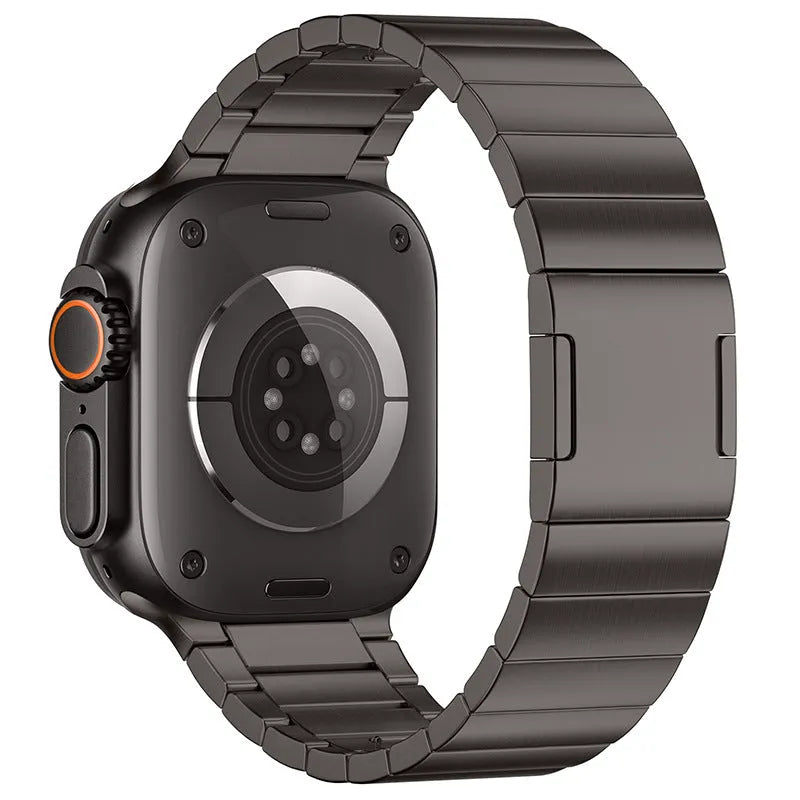 Stainless steel Apple Watch strap with magnetic buckle in multiple colour options on a wrist.